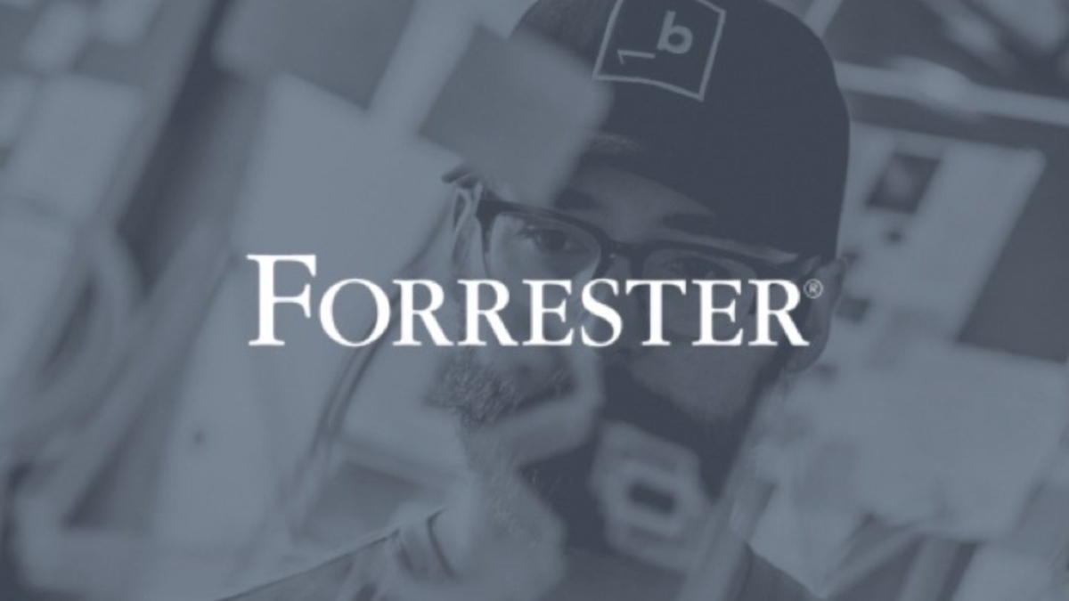 White Forrester logo against black & white photo of man working with post it notes.